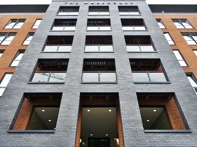 low angle view of a grey and brown apartment building