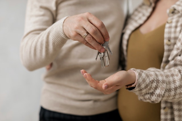 a-couple-holding-the-keys-for-a-new-house